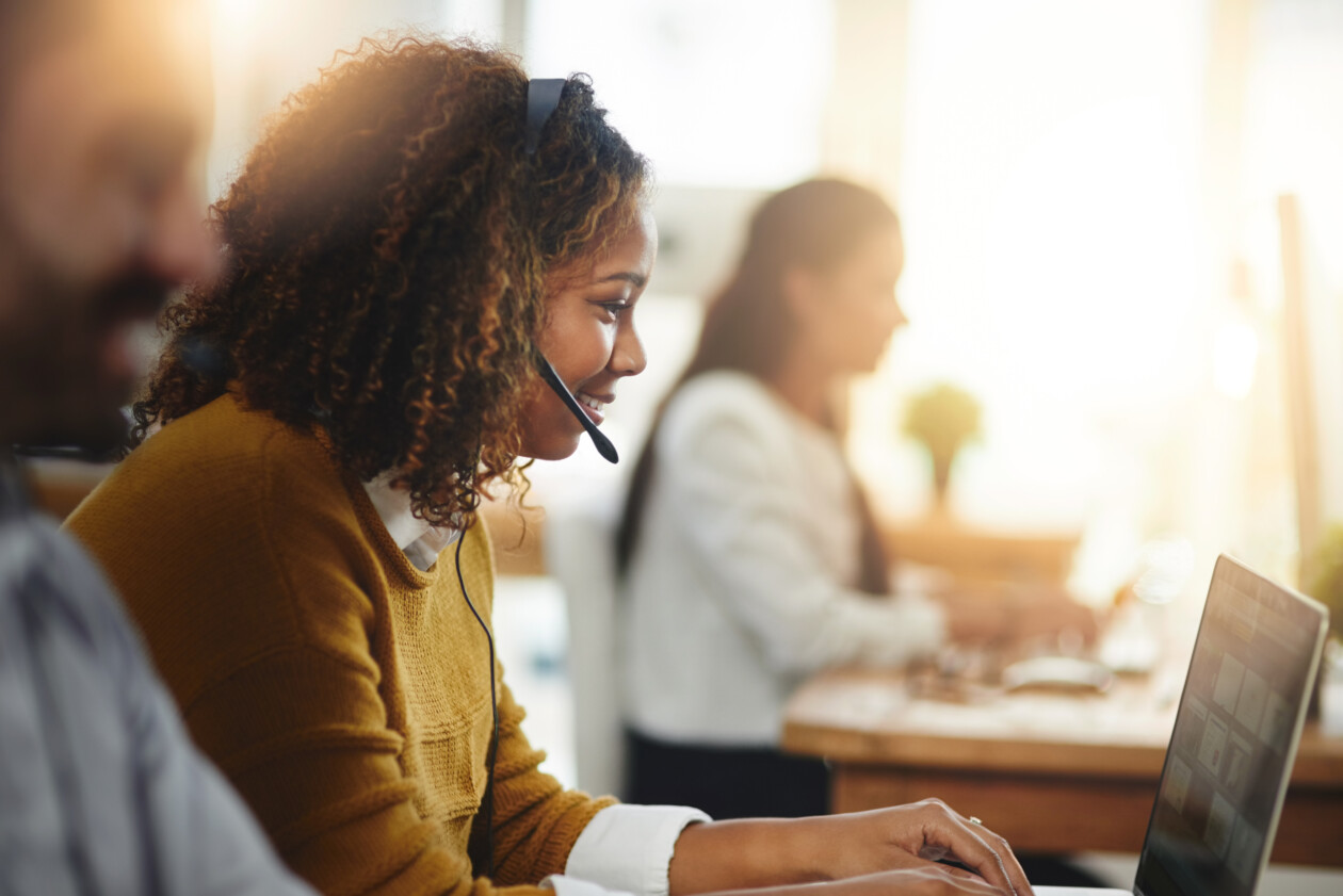 Contact us, coworking or happy woman in call center consulting or typing on laptop at customer services. virtual assistant, girl or sales consultant in telemarketing or telecom company help desk