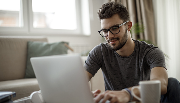 Young man using social media at home