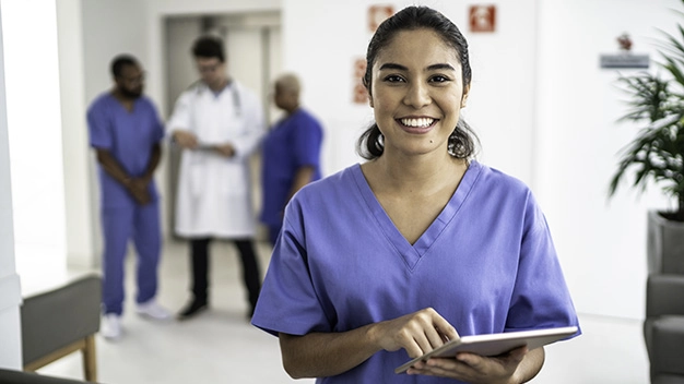 Portrait of female nurse using tablet at hospital