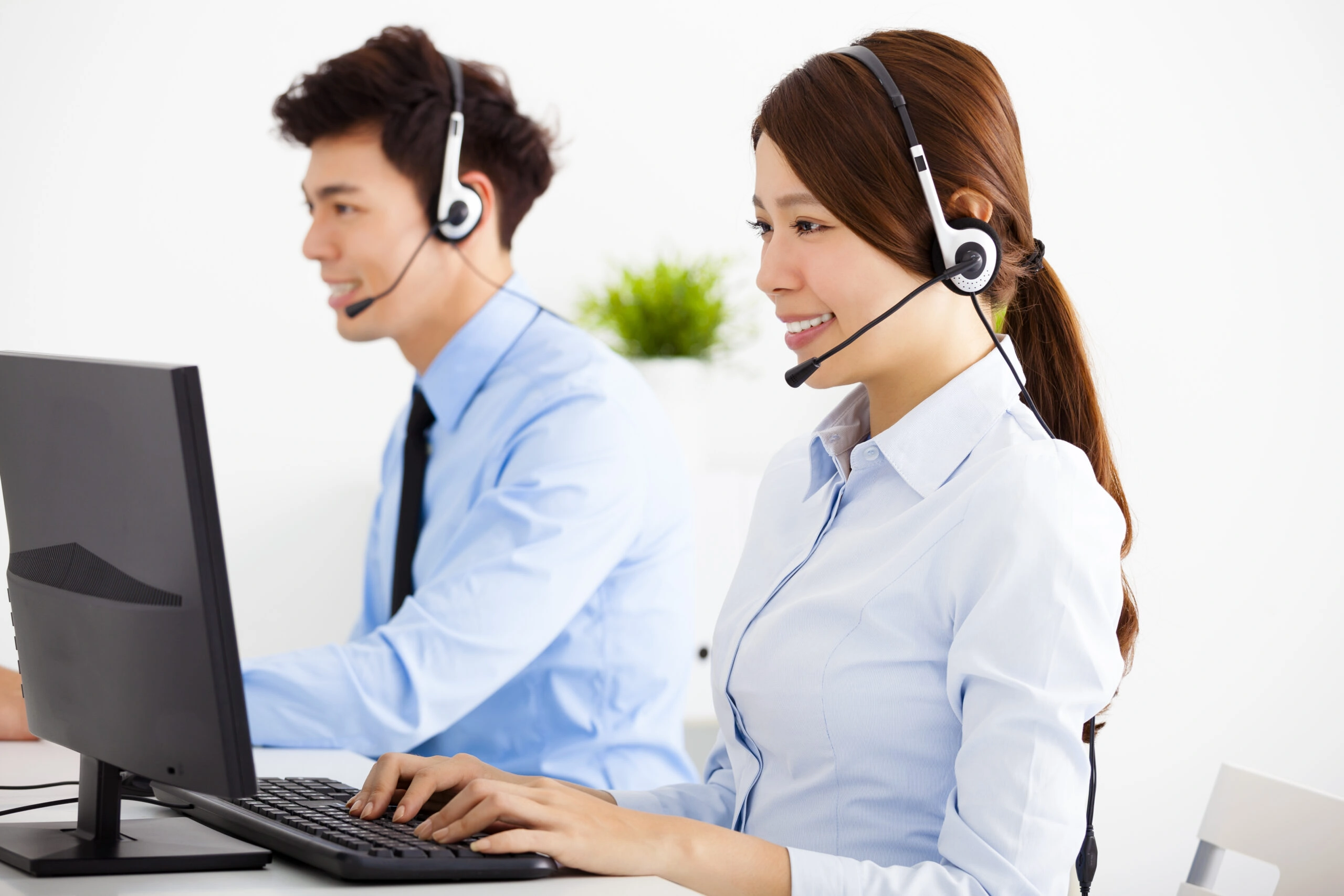 Smiling,business,man,and,woman,with,headset,working,in,office